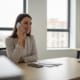 A Local Business Owner Is Engaged In Answering Phone Calls In A Modern Office Setting, Surrounded By Mobile Devices And Marketing Materials That Emphasize Customer Testimonials And Strategies To Attract Customers. This Scene Highlights The Importance Of Effective Communication In Enhancing The Customer Journey And Increasing Sales Through Mobile-Friendly Practices.